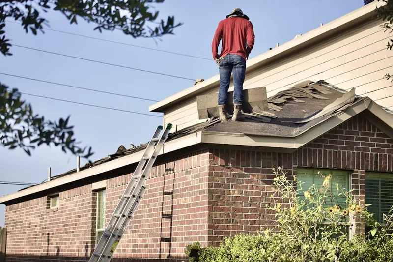 Professional roofer working on a residential roof in Freys Grove
